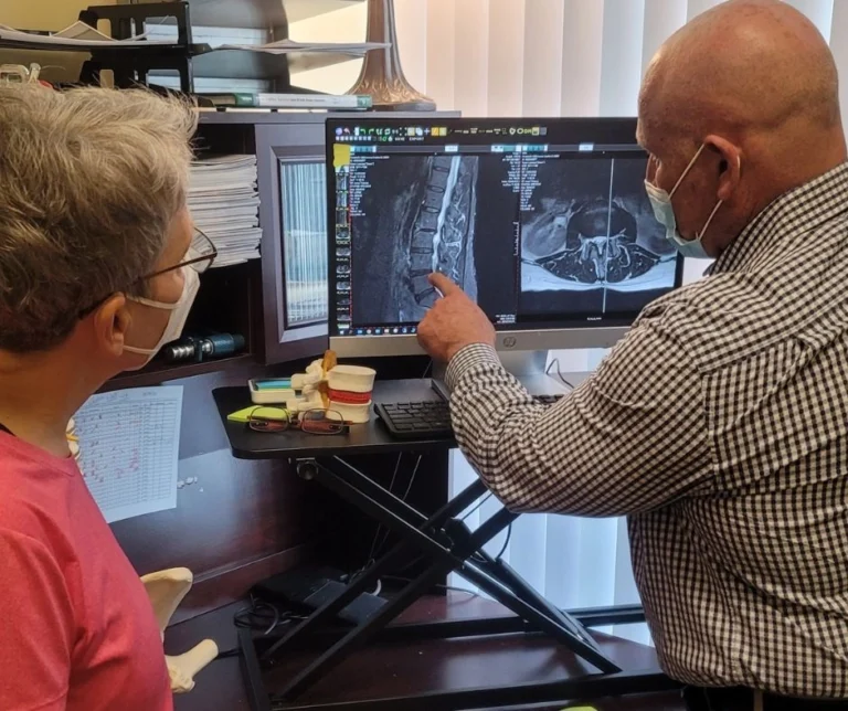 Dr. Brent Wells explaining an x-ray image to a patient.