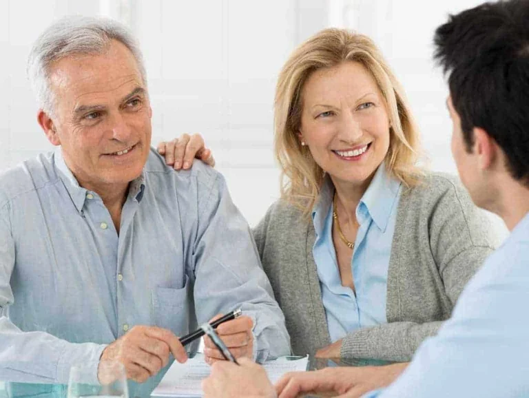 A couple discussing with a person.