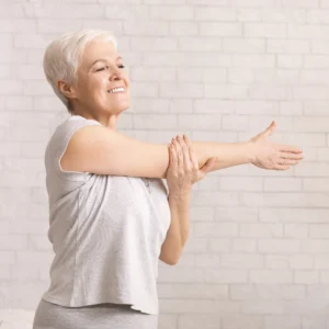 A woman stretching her shoulder.