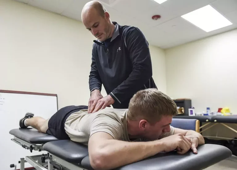 A man being attended by a chiropractor.