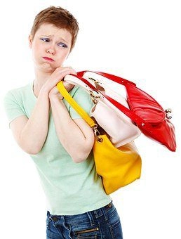 A woman carrying many bags.