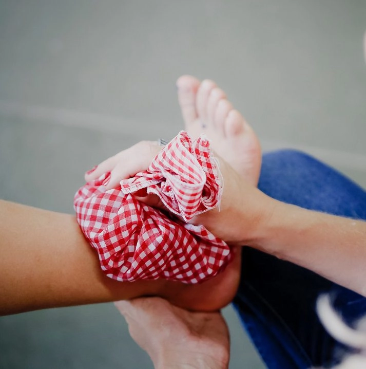 A foot with an ice pack on the ankle.