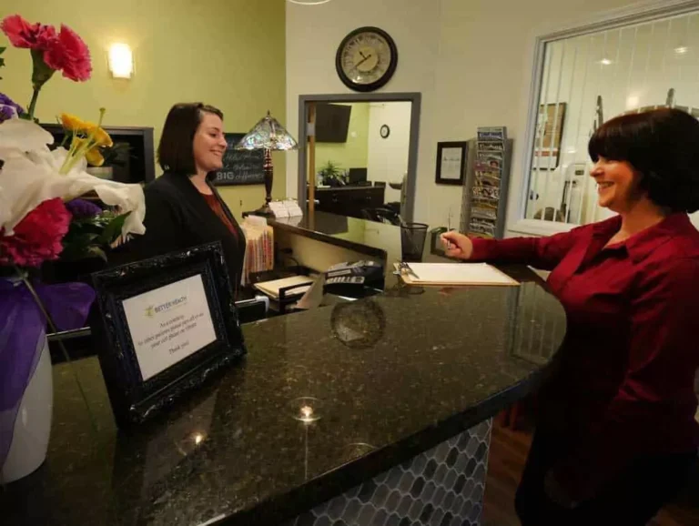 Two women talking in the reception of Better Health Alaska.